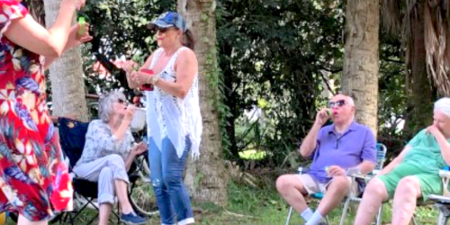 people in grove blowing bubbles